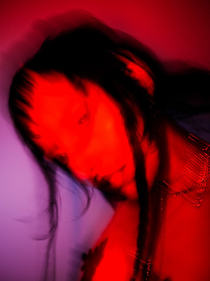 Lindred portrait in red light, blurred motion